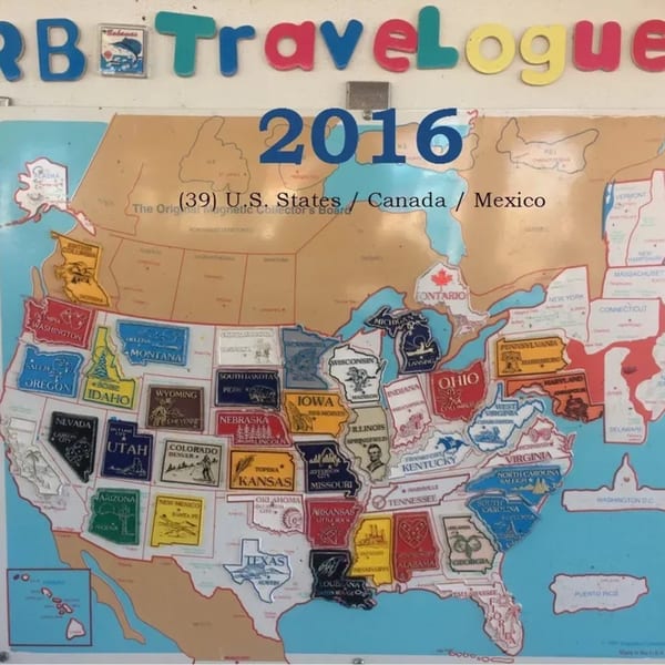 A magnetic map of the US, Canada, and Mexico with many state magnets in place.
